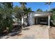 Exterior view of a charming home featuring a carport and lush greenery, exuding a welcoming curb appeal at 4142 N 35Th St, Phoenix, AZ 85018