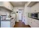 White kitchen featuring classic appliances, ample cabinet space, and a retro aesthetic, blending functionality and vintage charm at 4142 N 35Th St, Phoenix, AZ 85018
