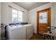 Bright laundry room with washer, dryer, and refinished concrete floors at 4142 N 35Th St, Phoenix, AZ 85018