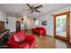 Bright living room featuring concrete floors, red sofas, piano, and an adjacent dining area for a cozy and inviting space at 4142 N 35Th St, Phoenix, AZ 85018