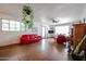 Living room featuring a red sofa and a piano, offering a bright space for relaxation and entertainment at 4142 N 35Th St, Phoenix, AZ 85018