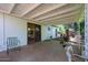 Covered patio with outdoor seating space, perfect for enjoying the serene backyard with mature landscaping at 4142 N 35Th St, Phoenix, AZ 85018