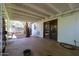 Covered patio with whitewashed brick and exposed ceiling joists opens to a spacious backyard with mature trees at 4142 N 35Th St, Phoenix, AZ 85018