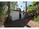Exterior view of backyard shed with wood siding and a black door, surrounded by mature trees at 4142 N 35Th St, Phoenix, AZ 85018