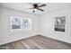 Inviting bedroom featuring wood-look floors, a modern ceiling fan, and natural light at 432 W 1St St, Mesa, AZ 85201