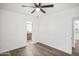 Bedroom featuring light walls, wood-look flooring, and an adjacent bathroom at 432 W 1St St, Mesa, AZ 85201