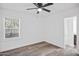 Bright bedroom with wood-look floors, ceiling fan, and large window at 432 W 1St St, Mesa, AZ 85201