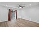 Spacious bedroom features a ceiling fan, sliding glass door and wood-look flooring at 432 W 1St St, Mesa, AZ 85201