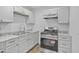 Kitchen has stainless steel appliances, white cabinets and wood look flooring at 432 W 1St St, Mesa, AZ 85201