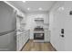 Kitchen has stainless steel appliances, white cabinets and wood look flooring at 432 W 1St St, Mesa, AZ 85201