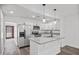 Well-lit kitchen featuring granite countertops, stainless steel appliances, and stylish pendant lights at 432 W 1St St, Mesa, AZ 85201