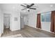 Open-concept living room with wood-look flooring leads to bathroom and kitchen at 432 W 1St St, Mesa, AZ 85201