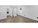 Open living space featuring wood flooring, a window, and a doorway to the bathroom at 432 W 1St St, Mesa, AZ 85201