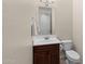 Powder room features a vanity, sink, mirror, and toilet at 4347 N 24Th Way, Phoenix, AZ 85016