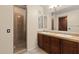 Bathroom featuring double sinks, cabinets, and a glass-enclosed shower at 4347 N 24Th Way, Phoenix, AZ 85016