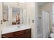 Bathroom featuring a wood vanity with a white countertop, a large mirror, and a shower at 4347 N 24Th Way, Phoenix, AZ 85016
