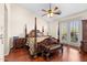 Bedroom featuring a four-poster bed, hardwood floors, and French doors leading to a balcony at 4347 N 24Th Way, Phoenix, AZ 85016