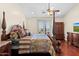 Bedroom with a four-poster bed, a ceiling fan, and doors to a balcony with golf course views at 4347 N 24Th Way, Phoenix, AZ 85016