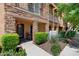Charming townhome featuring stone accents, iron railings, and lush landscaping at 4347 N 24Th Way, Phoenix, AZ 85016