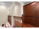 Hallway featuring hardwood floors, a wood railing, and a beautiful built-in cabinet at 4347 N 24Th Way, Phoenix, AZ 85016