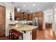 Well-lit kitchen features granite counters, stainless appliances, cherry cabinets and a breakfast bar with seating at 4347 N 24Th Way, Phoenix, AZ 85016