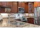Kitchen features stainless appliances, granite counters, and cherry cabinets at 4347 N 24Th Way, Phoenix, AZ 85016