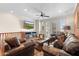 Cozy living room features a ceiling fan, TV, and an exposed brick wall at 4347 N 24Th Way, Phoenix, AZ 85016