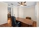 Well-lit office featuring a ceiling fan, beautiful hardwood floors, and a handsome executive desk at 4347 N 24Th Way, Phoenix, AZ 85016