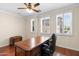 Office featuring a rich, wooden executive desk and two shuttered windows for bright, natural light at 4347 N 24Th Way, Phoenix, AZ 85016