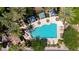 Aerial view of a community pool with cabanas, palm trees, and lounge chairs at 4347 N 24Th Way, Phoenix, AZ 85016