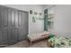 Neutral-colored bedroom featuring a window, a twin bed, artwork and gray walls at 4396 N School Hill Rd, Buckeye, AZ 85396