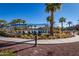 Resort-style community pool with covered lounge area and swaying palm trees on a bright, sunny day at 4396 N School Hill Rd, Buckeye, AZ 85396