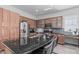 Modern kitchen boasts granite countertops, stainless steel appliances, a center island with seating, and plenty of cabinet space at 4396 N School Hill Rd, Buckeye, AZ 85396