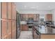 Modern kitchen featuring stainless steel appliances, granite countertops, custom cabinets, and a decorative tile backsplash at 4396 N School Hill Rd, Buckeye, AZ 85396