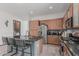 The modern kitchen features granite countertops, stainless steel appliances, a center island, and mosaic backsplash at 4396 N School Hill Rd, Buckeye, AZ 85396