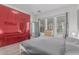 Bright bedroom featuring tile flooring, large windows, and red closets reflecting the bed at 4396 N School Hill Rd, Buckeye, AZ 85396