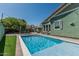 Beautiful backyard pool, surrounded by lush greenery, with outdoor dining and relaxation areas, ideal for entertaining at 4396 N School Hill Rd, Buckeye, AZ 85396