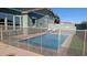 Backyard pool surrounded by a safety fence and patio, with comfortable lounge chairs and a view of the home at 4396 N School Hill Rd, Buckeye, AZ 85396
