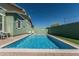 Inviting backyard pool with cool blue water, surrounded by a brick patio, and a clear blue sky overhead at 4396 N School Hill Rd, Buckeye, AZ 85396