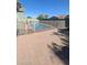 Backyard pool enclosed by a safety fence, featuring a tiled patio and clear blue water, perfect for Gathering fun at 4396 N School Hill Rd, Buckeye, AZ 85396