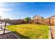 Large backyard with green grass, mature trees, and a privacy fence, offering ample space for recreation at 4580 E Gagarinite Ln, San Tan Valley, AZ 85143