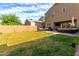 Expansive backyard with lush green lawn, privacy fence, and a covered patio area for entertaining at 4580 E Gagarinite Ln, San Tan Valley, AZ 85143