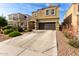 Inviting two-story home featuring a dark garage door and low-water landscaping at 4580 E Gagarinite Ln, San Tan Valley, AZ 85143