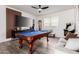 Well-lit game room featuring a pool table, entertainment center, and modern decor at 4580 E Gagarinite Ln, San Tan Valley, AZ 85143