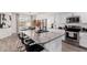 Open concept kitchen island with bar stool seating and sleek granite countertops at 4580 E Gagarinite Ln, San Tan Valley, AZ 85143