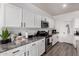 Modern kitchen featuring white cabinets, gray countertops, and stainless steel appliances at 4580 E Gagarinite Ln, San Tan Valley, AZ 85143