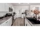 Modern kitchen with white cabinets, stainless steel appliances, and granite countertops at 4580 E Gagarinite Ln, San Tan Valley, AZ 85143
