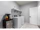 Well-lit laundry room featuring a washer, dryer, storage shelves, and a mini refrigerator perfect for refreshments at 4580 E Gagarinite Ln, San Tan Valley, AZ 85143