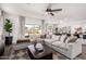 Open-concept living room and dining area with a large sectional sofa at 4580 E Gagarinite Ln, San Tan Valley, AZ 85143