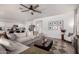Open-concept living room featuring a large sectional sofa, ceiling fan, and adjacent kitchen at 4580 E Gagarinite Ln, San Tan Valley, AZ 85143
